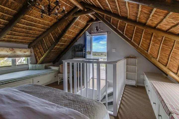 Vaulted thatched ceiling above a bedroom